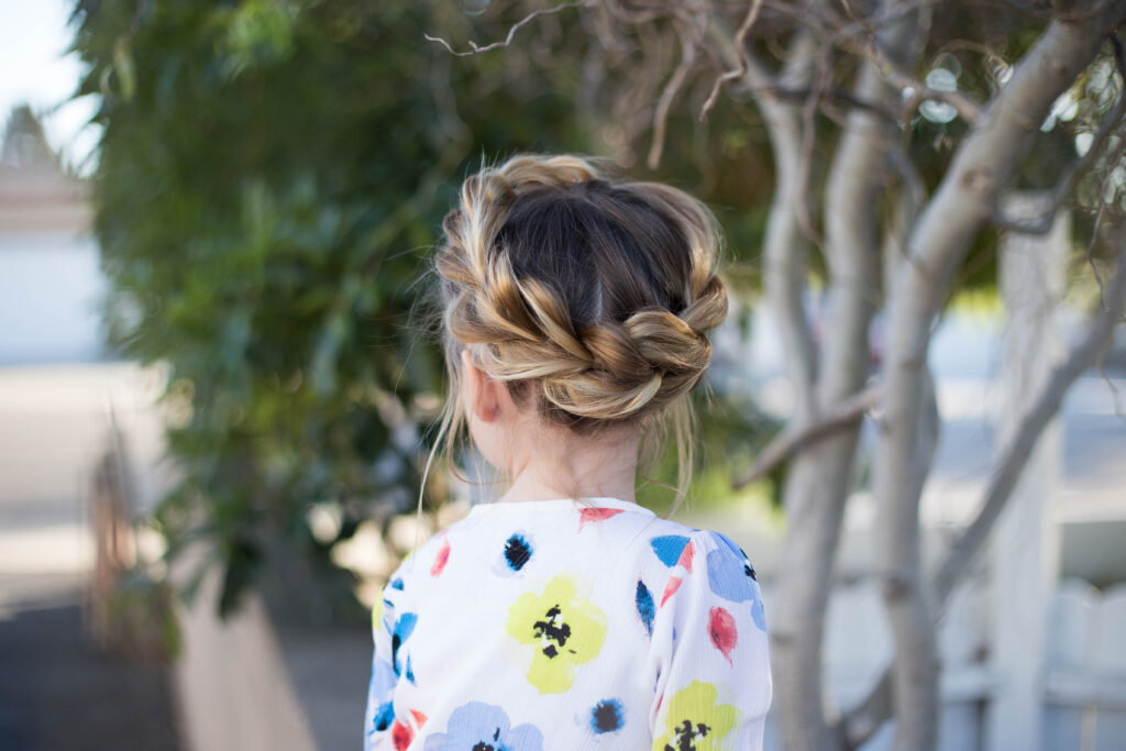 Back view of young girl outside modeling "Pull-Thru Crown Braid" hairstyle