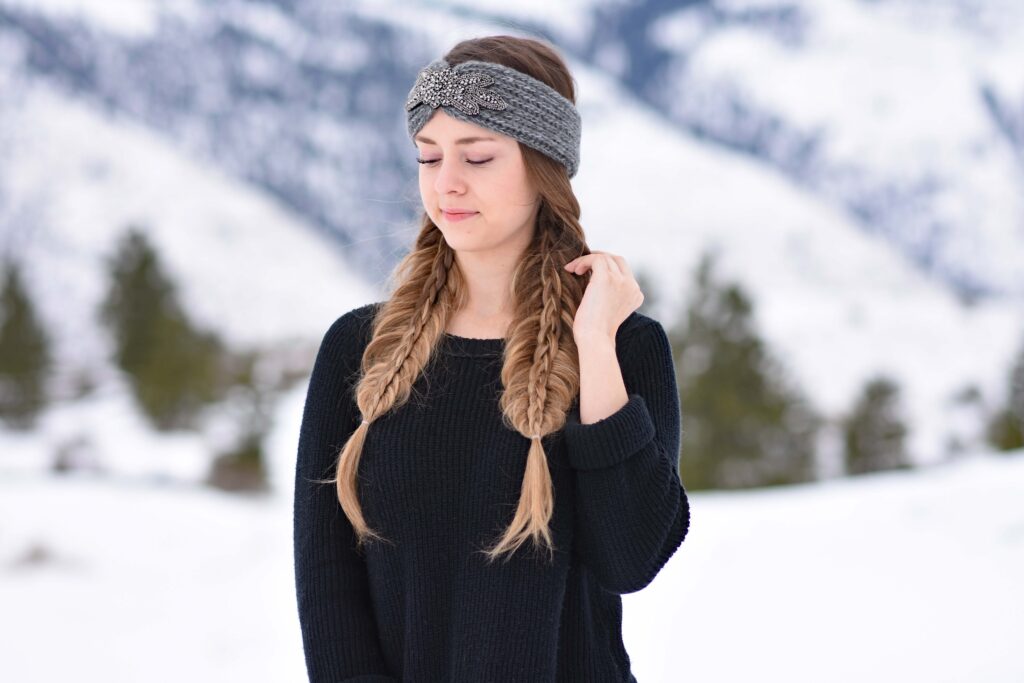 Portrait of young girl wearing a gray headband modeling "Double Stacked Fishtail" hairstyle