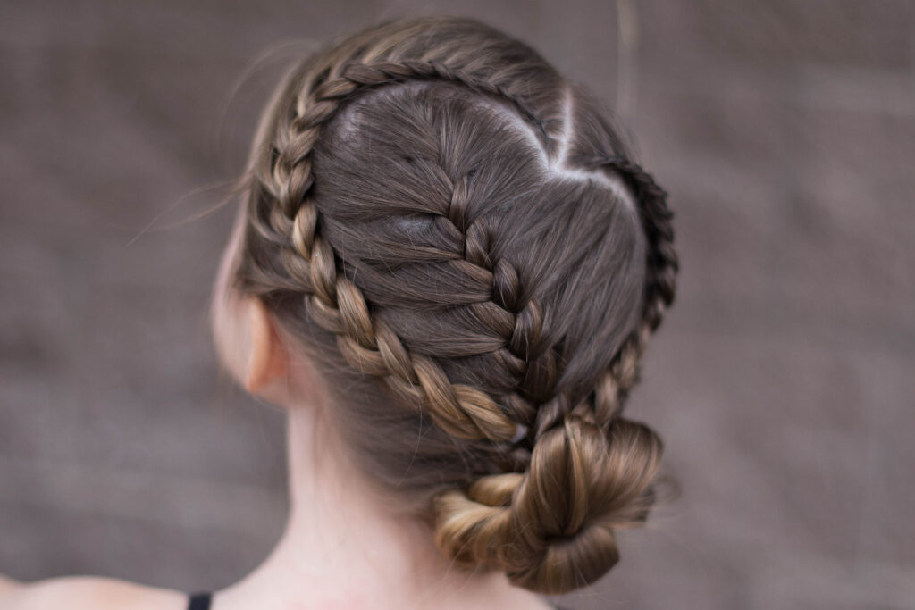 Back view of a young girl modeling "Sweetheart Braid Combo" hairstyle