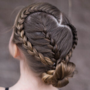 Back view of a young girl modeling "Sweetheart Braid Combo" hairstyle