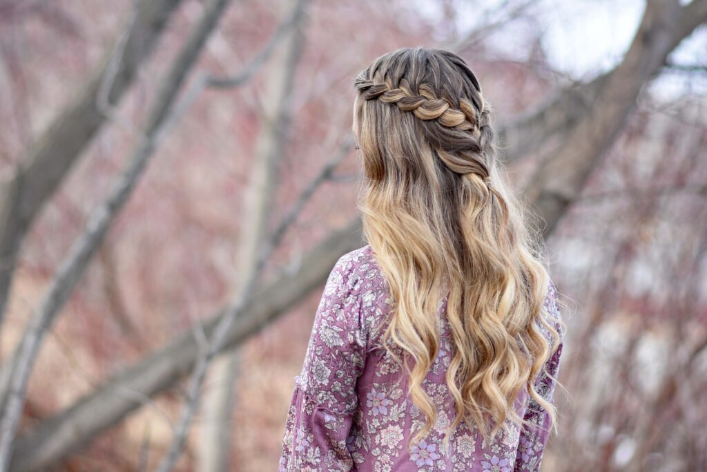 Side view of girl standing outside modeling the "Lace Half Up" hairstyle