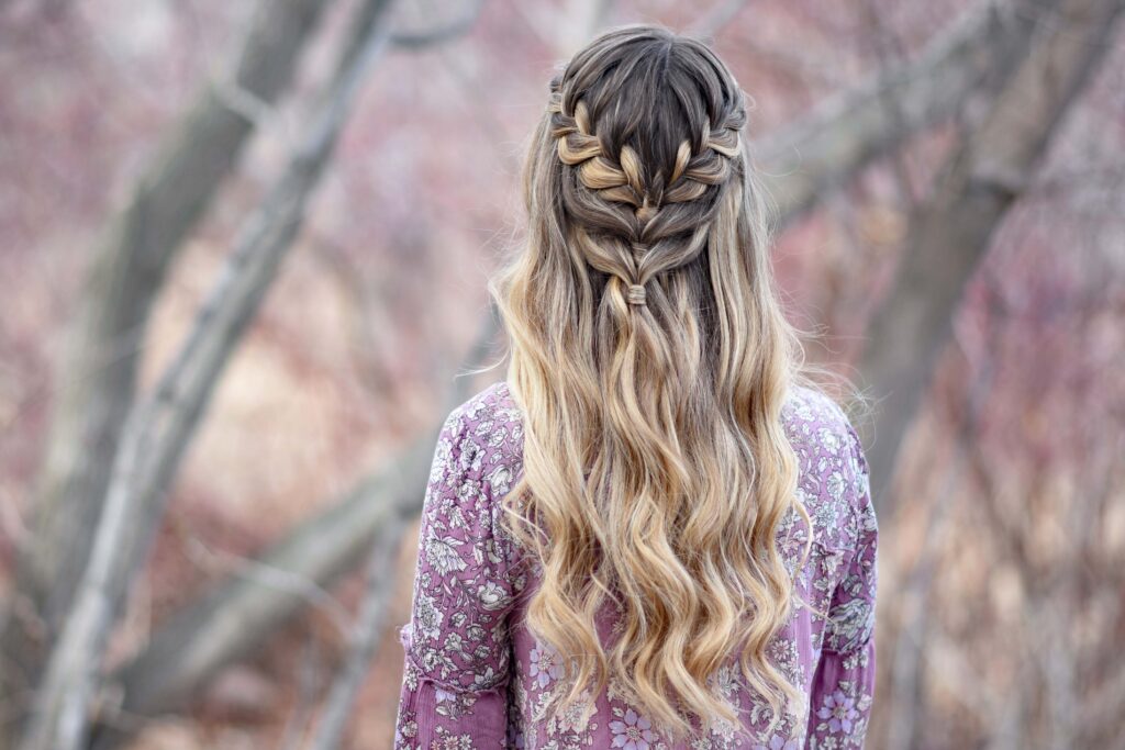 Back view of girl standing outside modeling the "Lace Half Up" hairstyle