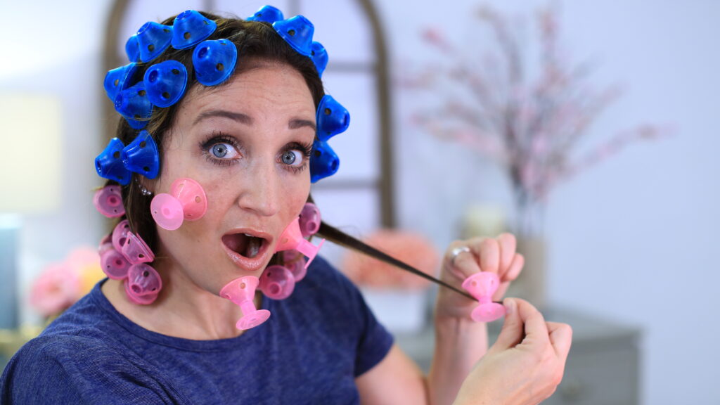 Shocked woman testing new hair styling tool