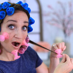 Shocked woman testing new hair styling tool