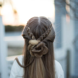 Profile for a young girl outside modeling cute "Braided Bun Combo" hairstyle