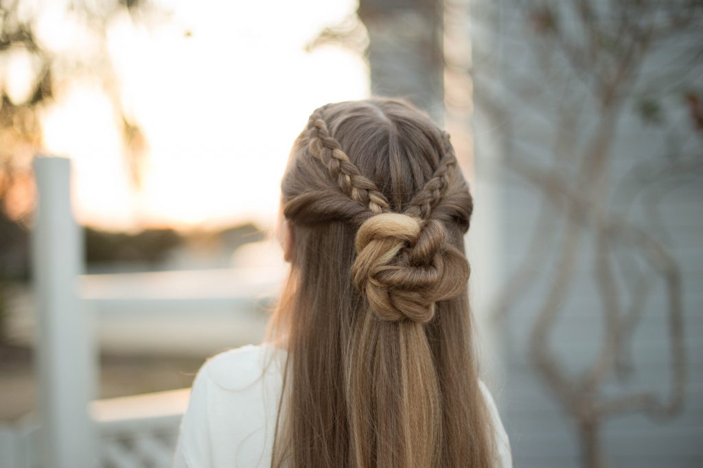 Close up back view of a young girl outside modeling cute "Braided Bun Combo" hairstyle