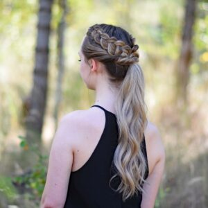 Side view of a young girl wearing a black shirt standing in the meadow modeling "Twisted Dutch Braid Ponytail" hairstyle