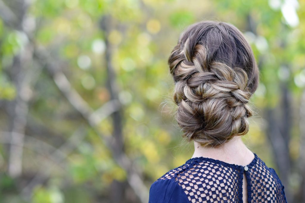 Back view of girl standing outside modeling the "French Braid Updo" hairstyle