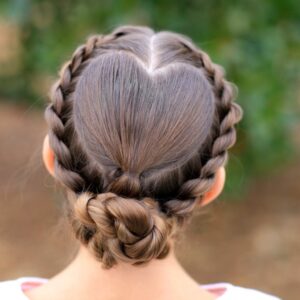 Girl standing outside wearing a white shirt modeling "Rope Twisted Heart" hairstyle