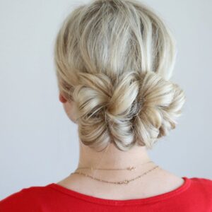 Back view of woman standing in front of a white background modeling the "Pull Thru updo" hairstyle