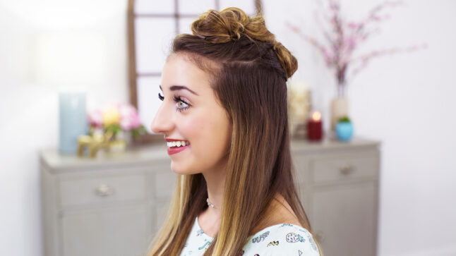 Side view of a girl smiling sitting in her room modeling "Triple Top Knot" hairstyle