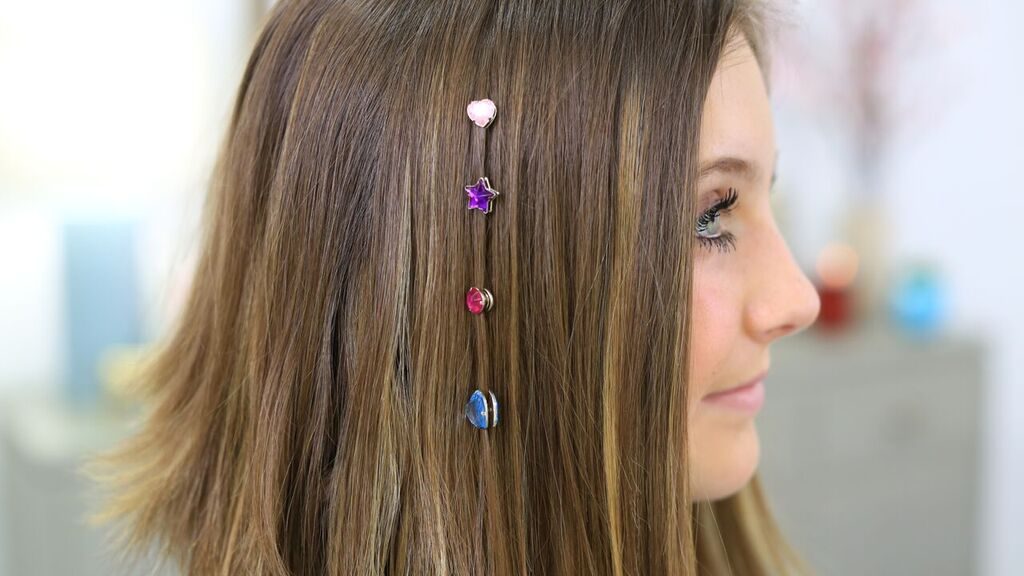 Close-up of young girl with glitter accessories in her hair