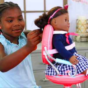 Young African American girl playing indoors with her doll