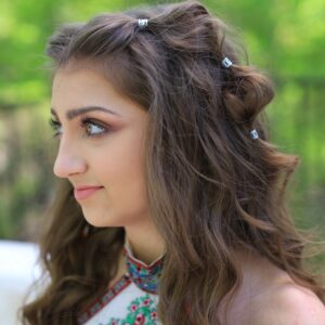 Side view of girl with long hair smiling while standing outside modeling "Boho Bubble Braids" hairstyle