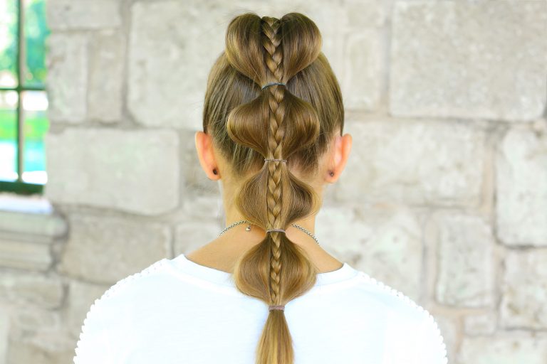 Back view of girl with white shirt standing outside modeling "Stacked Bubble Braid" hairstyle