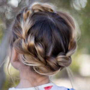 Back view of young girl standing outside modeling "Pull-Thru Crown Braid" hairstyle