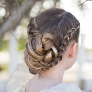 back view of young girl standing outside modeling "Braided Bun Updo" hairstyle