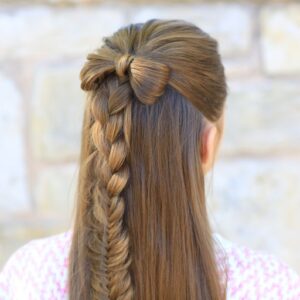 Back view of girl with pink shirt standing outside modeling "Half-up Bow" hairstyle