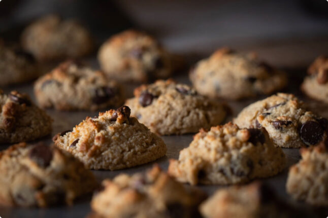 chocolate chip cookies rising on a pan