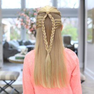 Back view of a girl wearing a pink shirt modeling the Mermaid Loop Braid