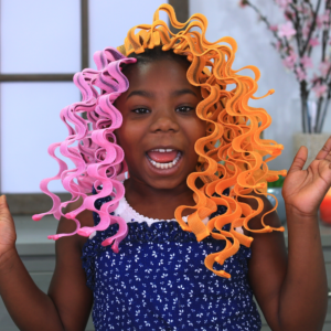 Little girl excited as she gets her hair styled